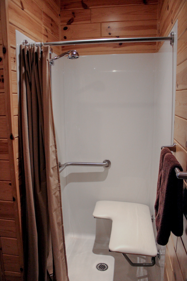 Cabin standing/roll-in shower including foldable shower seat, grab bar, and low-entry. Pictured are 