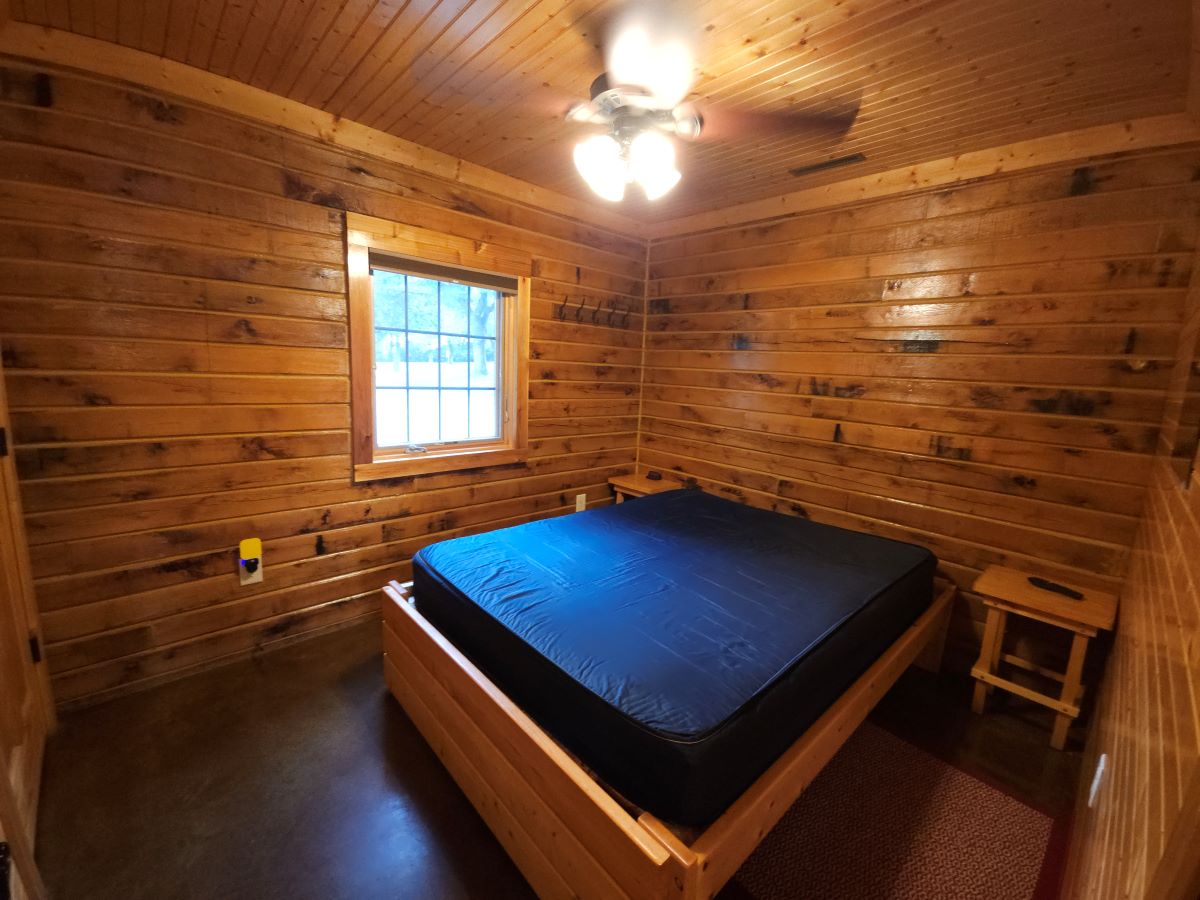 Lakeview cabin main floor bedroom 1 with queen bed