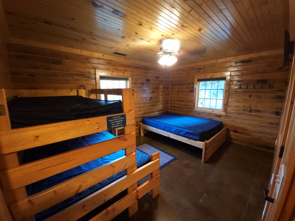 Lakeview cabin main floor bedroom 2 with queen bed, full size bed with twin bunk.