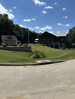 View of Rock sign with the centers logo on it with the center in the background.