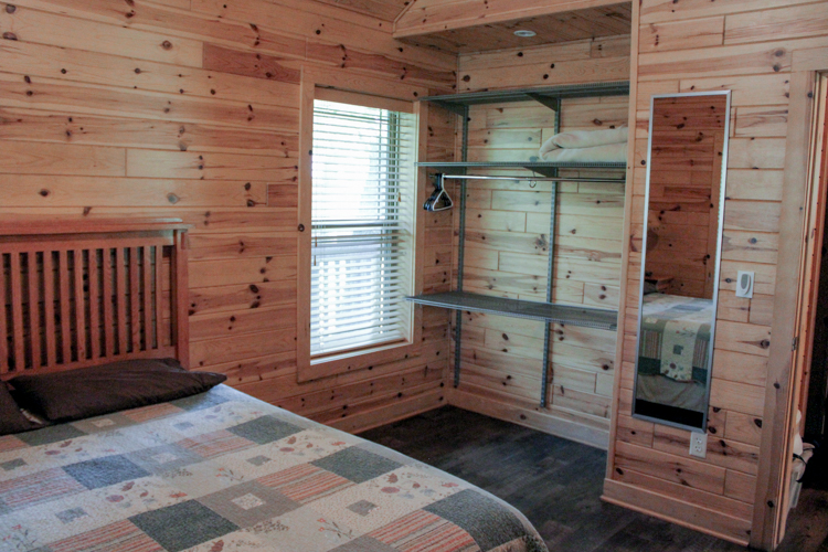 Second view of cabin 3 second bedroom showing mounted shelving 