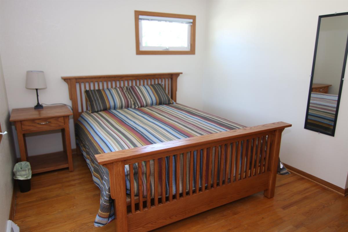 Second view of Main bedroom including small additional window and full-length mirror