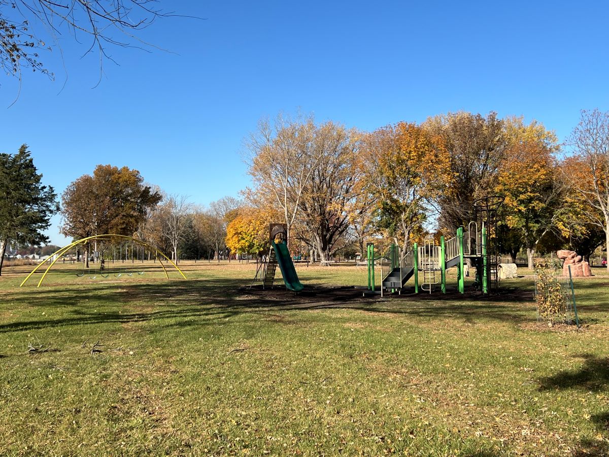 Mill Creek park playground with three tall slides, climbing tower and monkey bars