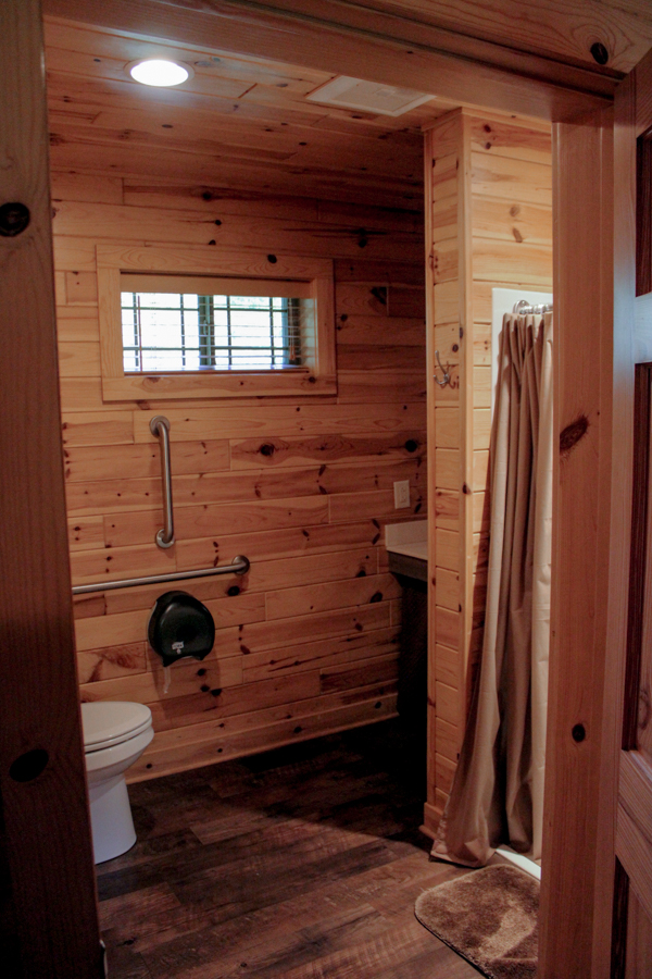 Cabin 4 main level bathroom including safety bars on toilet and low-entry standup/roll-in shower