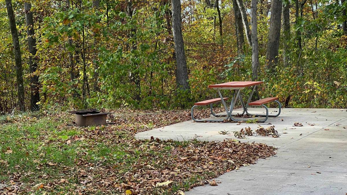 Concrete campsite with fire ring and picnic table