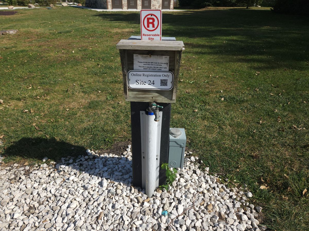 Site 24 - Pedestal with water, electric and sewer hookup; Back-in site