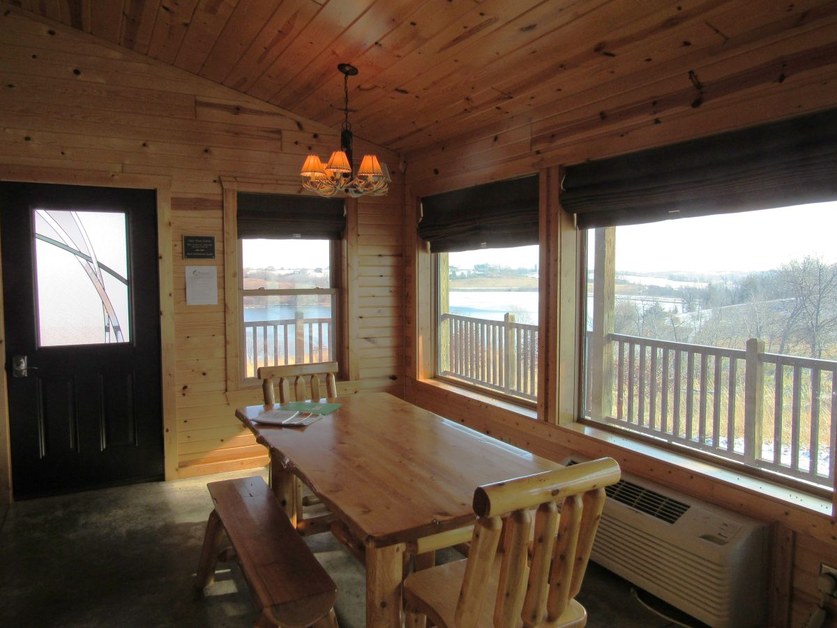 Lakeview Cabin - Common area with dinning table that looks out onto Lake Iowa