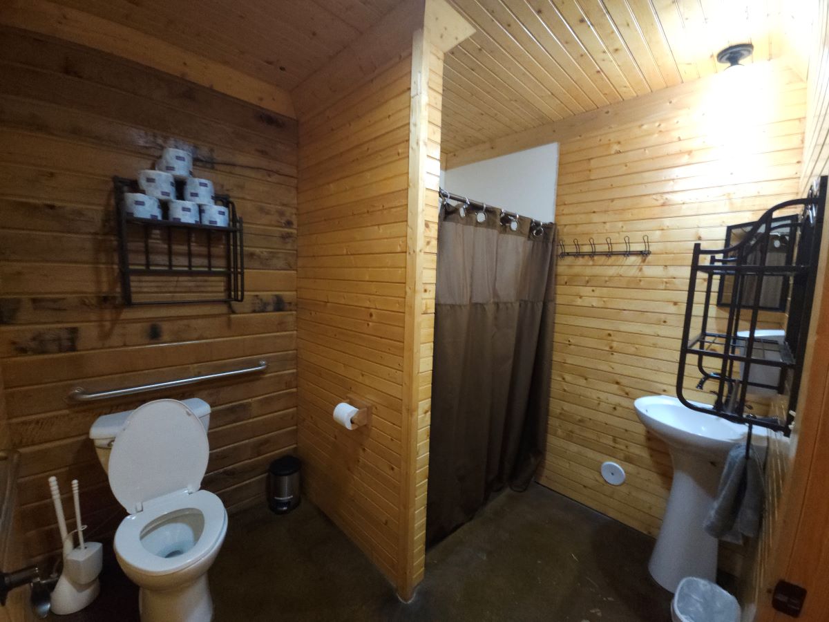 Lakeview cabin downstairs bathroom with shower and sink. Handicap accessible