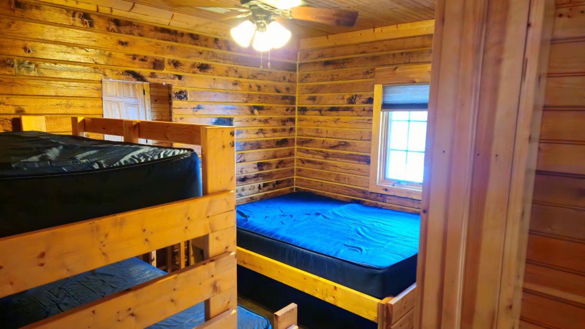 Oak Cabin bedroom 1 with queen bed, full size bed with twin bunk above.