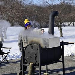 Lady stirring the maple sap as it cooks