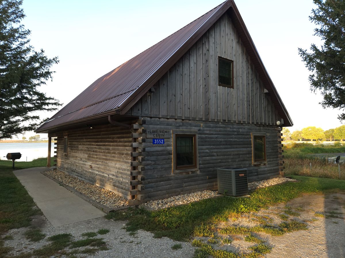 Lakeview cabin next to the parking lot, with sidewalk to front door, charcoal grill at the corner