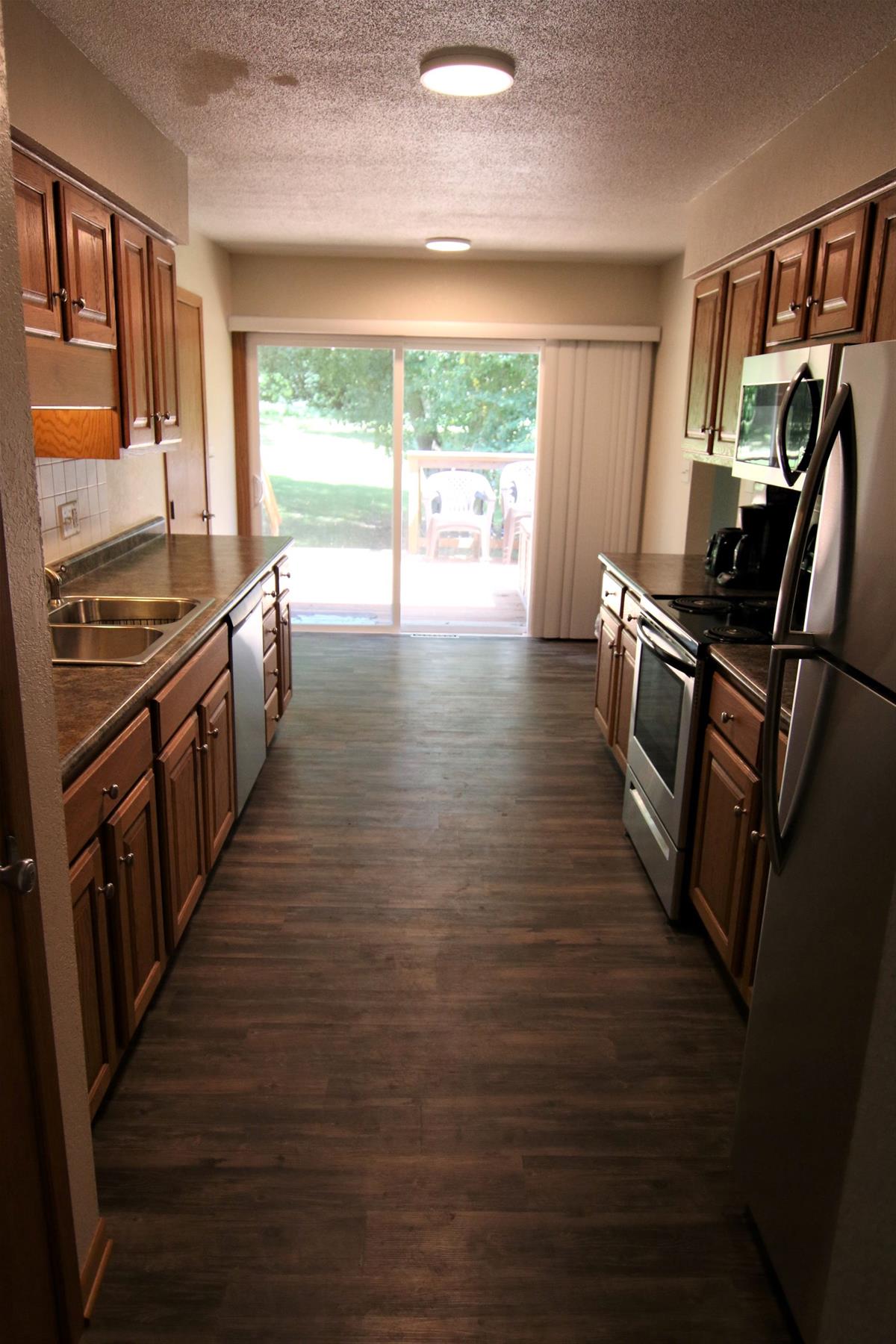 Thomas Mitchell Cabin kitchen including view off to the side of the home, as well as stainless steel