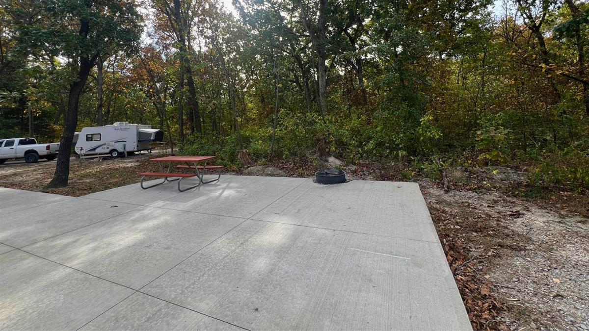 Concrete campsite with fire ring and picnic table