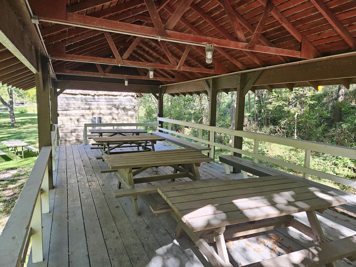 Bell's Mill open shelter with 4 picnic tables and seating bench. Electric outlets and lights.