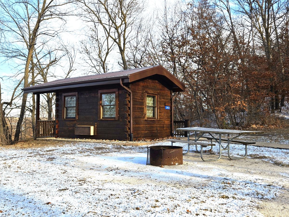 Cabin outside showing fire ring and picnic table